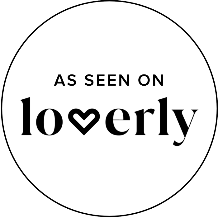 Black and white circular badge with the text 'As seen on lovingly' and a heart shape inside the letter 'v' in 'lovely'.